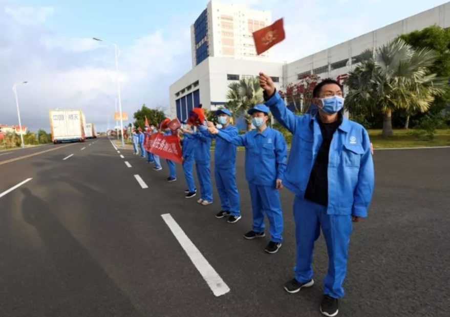 Masked workers welcome the Long March 5B components to Wenchang Satellite Launch Center.